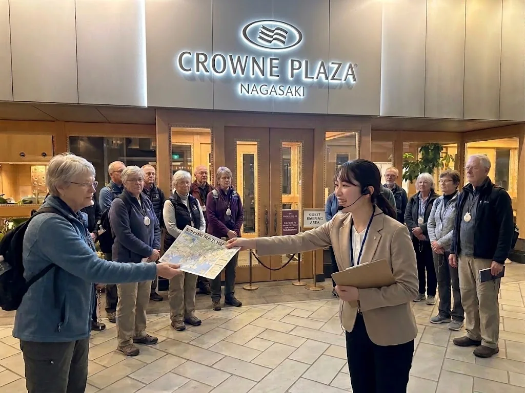 A guide welcoming pilgrims at Crowne Plaza Nagasaki